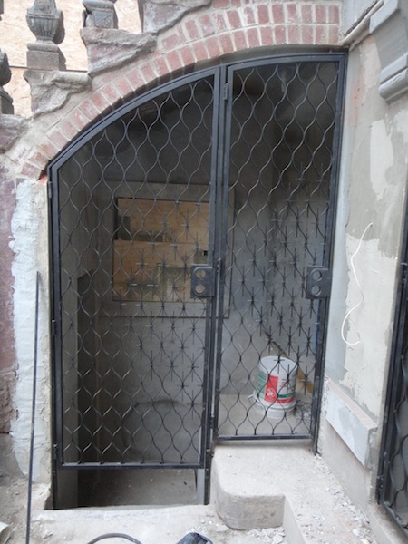 new under stoop gates on Harlem brownstone new under stoop gates on Harlem brownstone